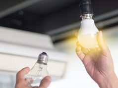 Hand with a lit light bulb