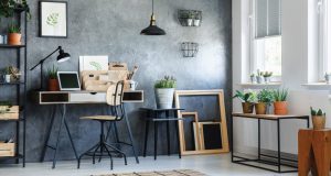 room with a wooden chair and black pendant lamp