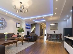 living room with wood floors and black sofa set