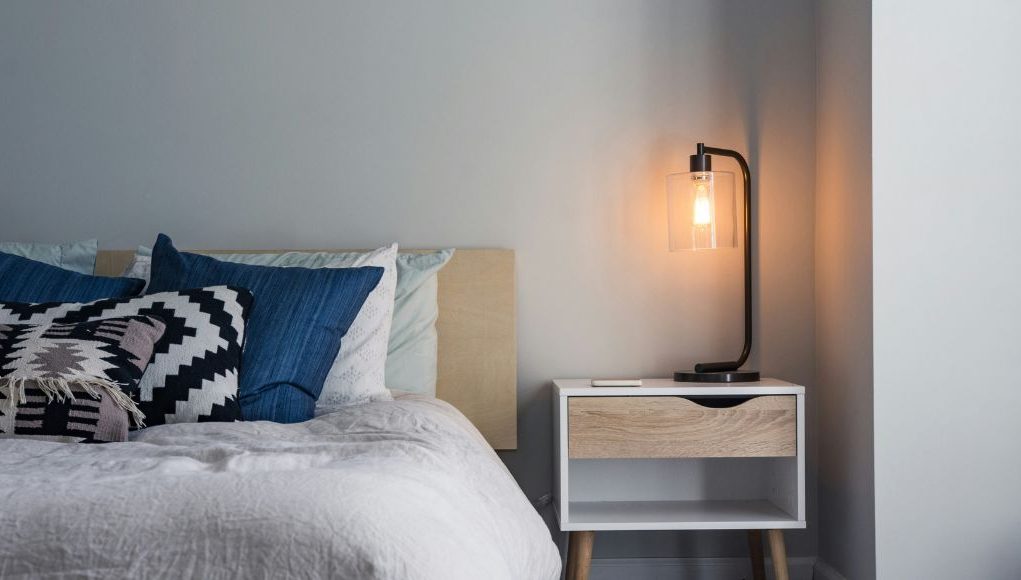 bedroom with warm white bedside table lamp