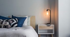 bedroom with warm white bedside table lamp