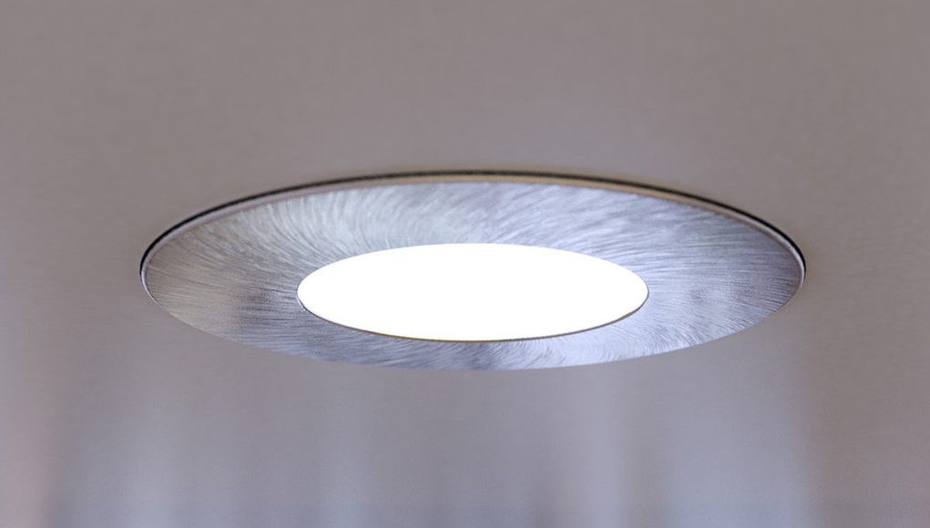 A close up of an LED downlight brightening up a living room.