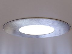 A close up of an LED downlight brightening up a living room.