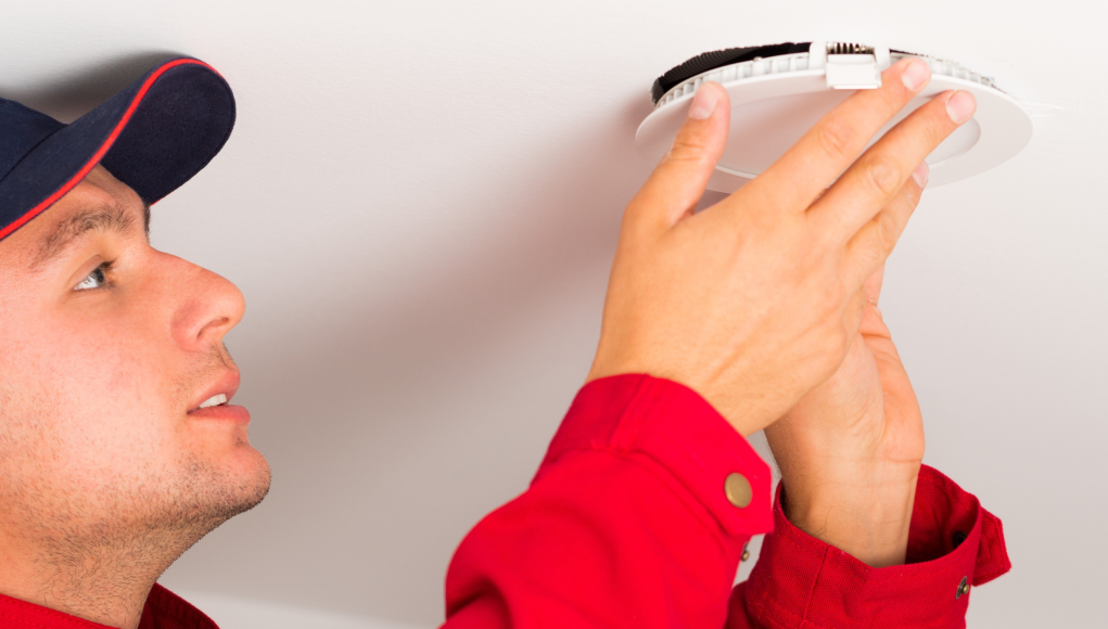 Man installing LED downlights on ceilings.