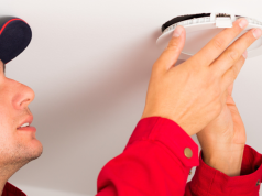 Man installing LED downlights on ceilings.