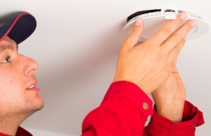 Man installing LED downlights on ceilings.